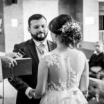 A heartfelt black and white moment at a wedding ceremony with bride and groom exchanging vows.